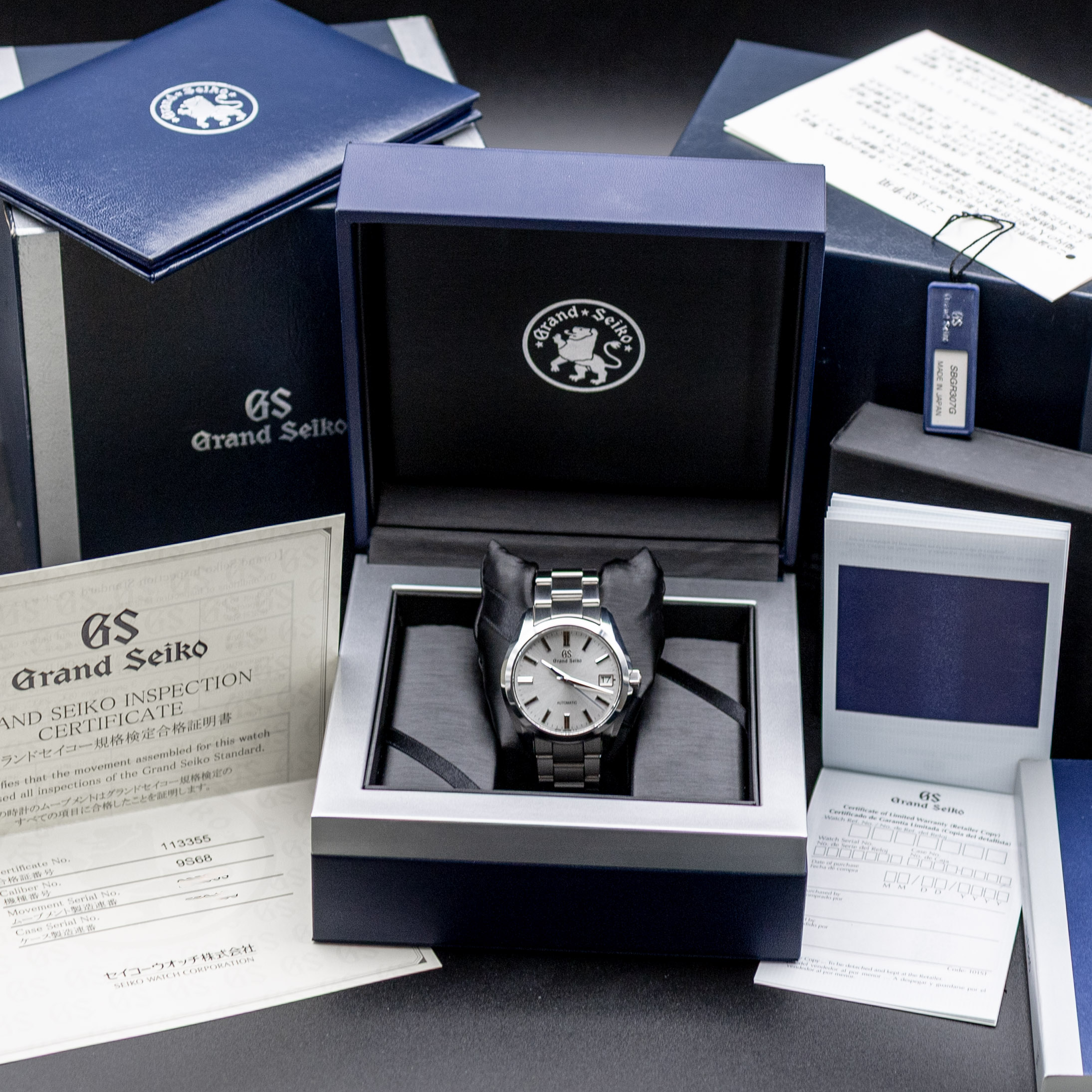 Grand Seiko SBGR307 silver sunburst dial with applied indices and blue seconds hand