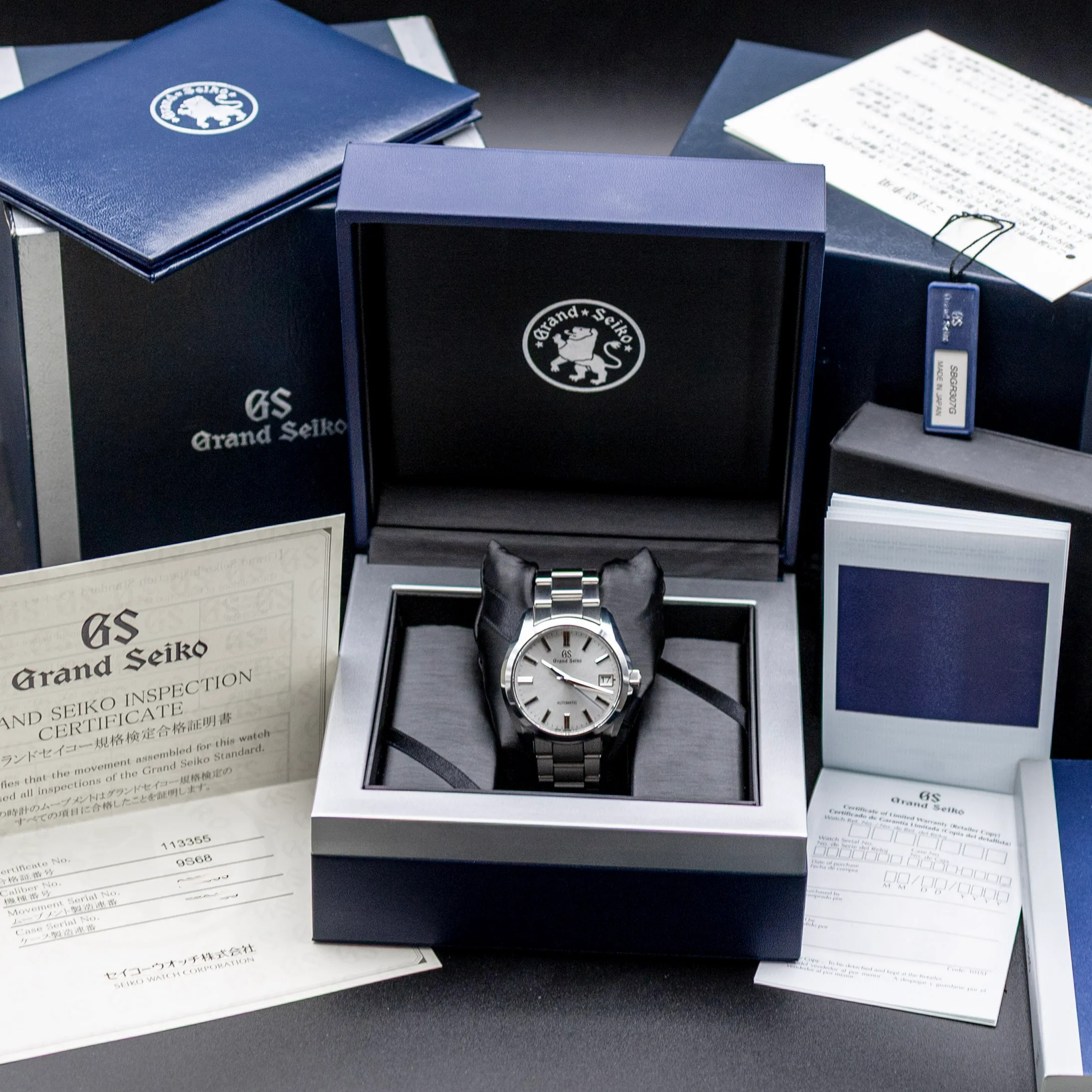 Grand Seiko SBGR307 silver sunburst dial with applied indices and blue seconds hand