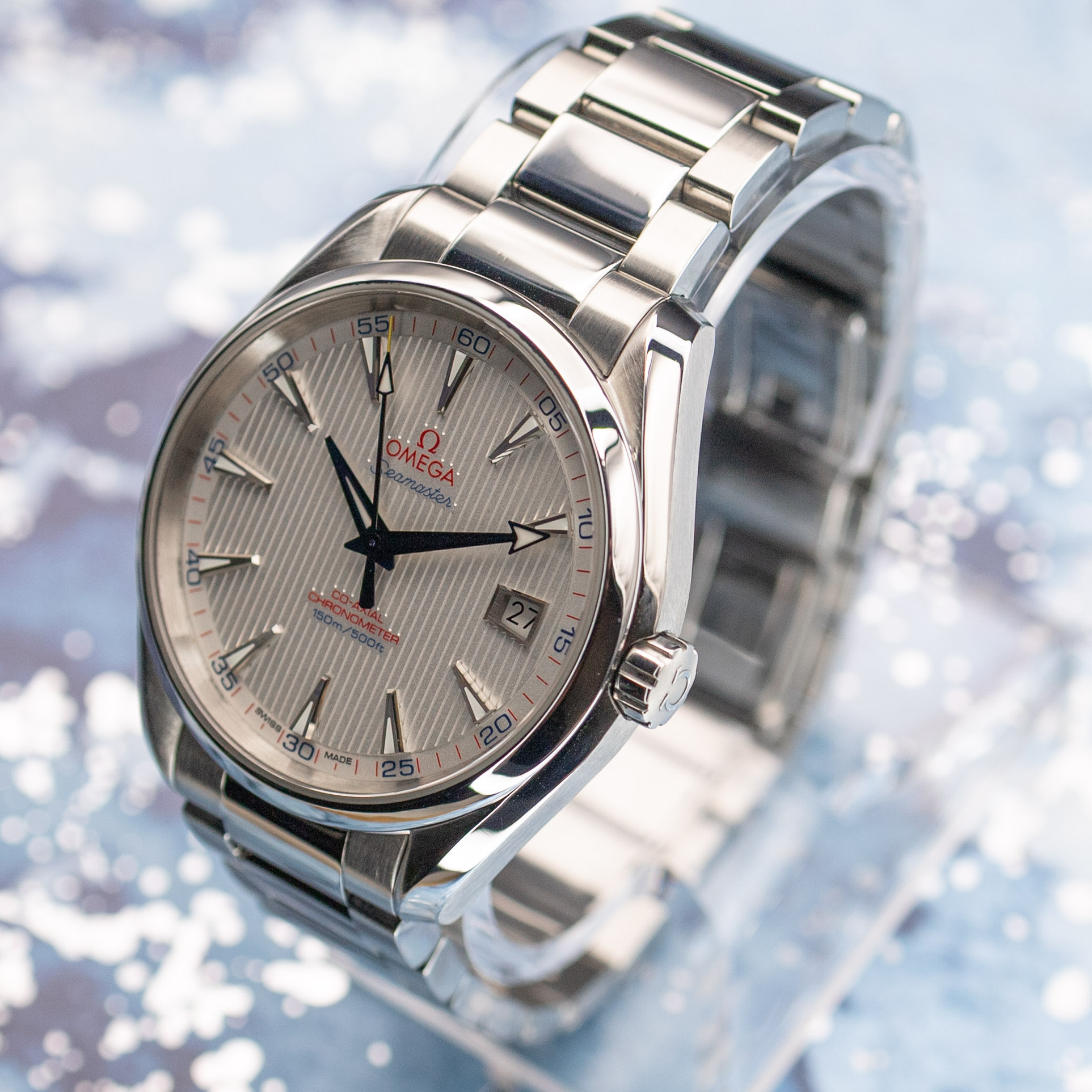Omega Aqua Terra Captain's Watch dial at angle showing teak texture and light play