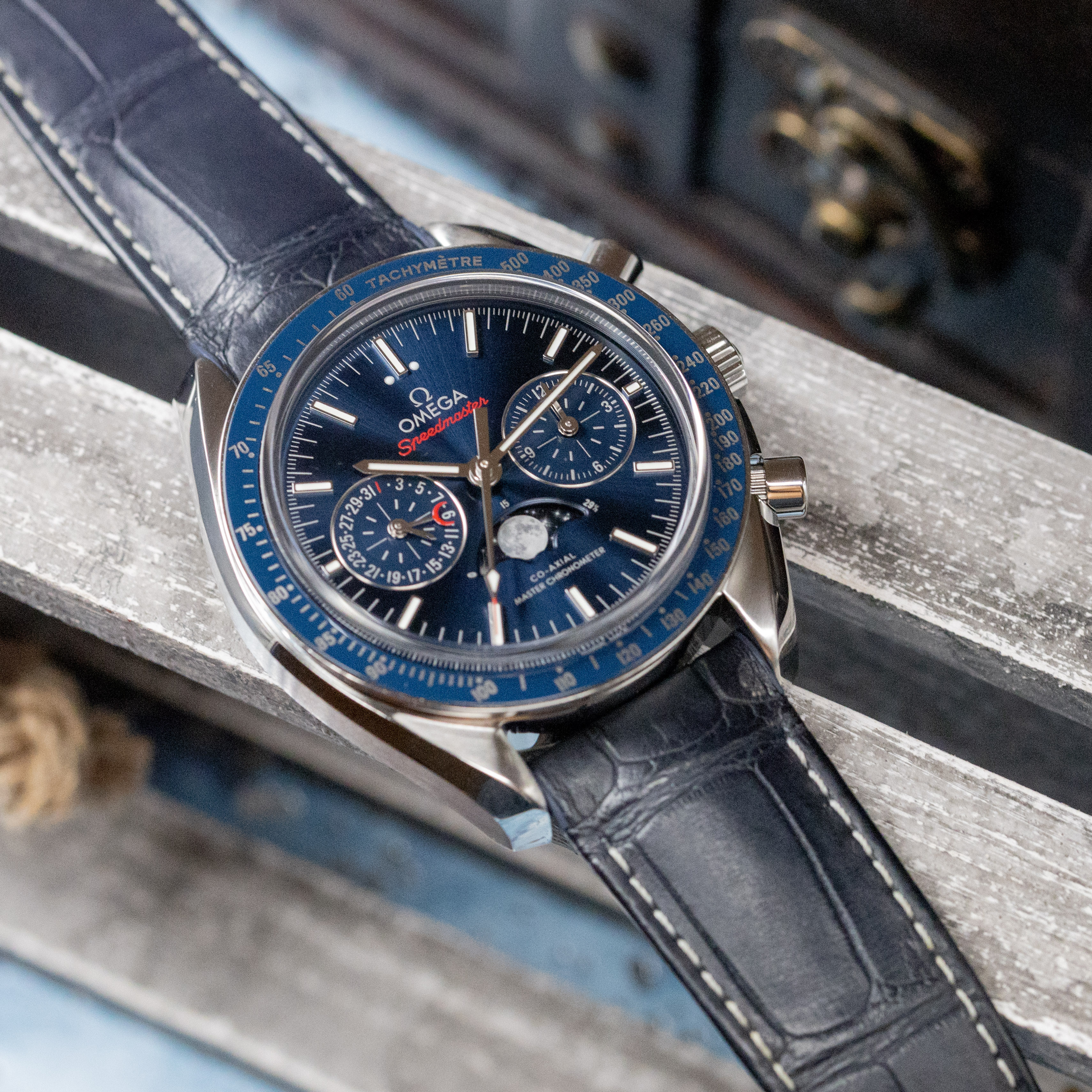 Omega Speedmaster Moonphase blue dial front view showing moonphase disc and red crescent date hand