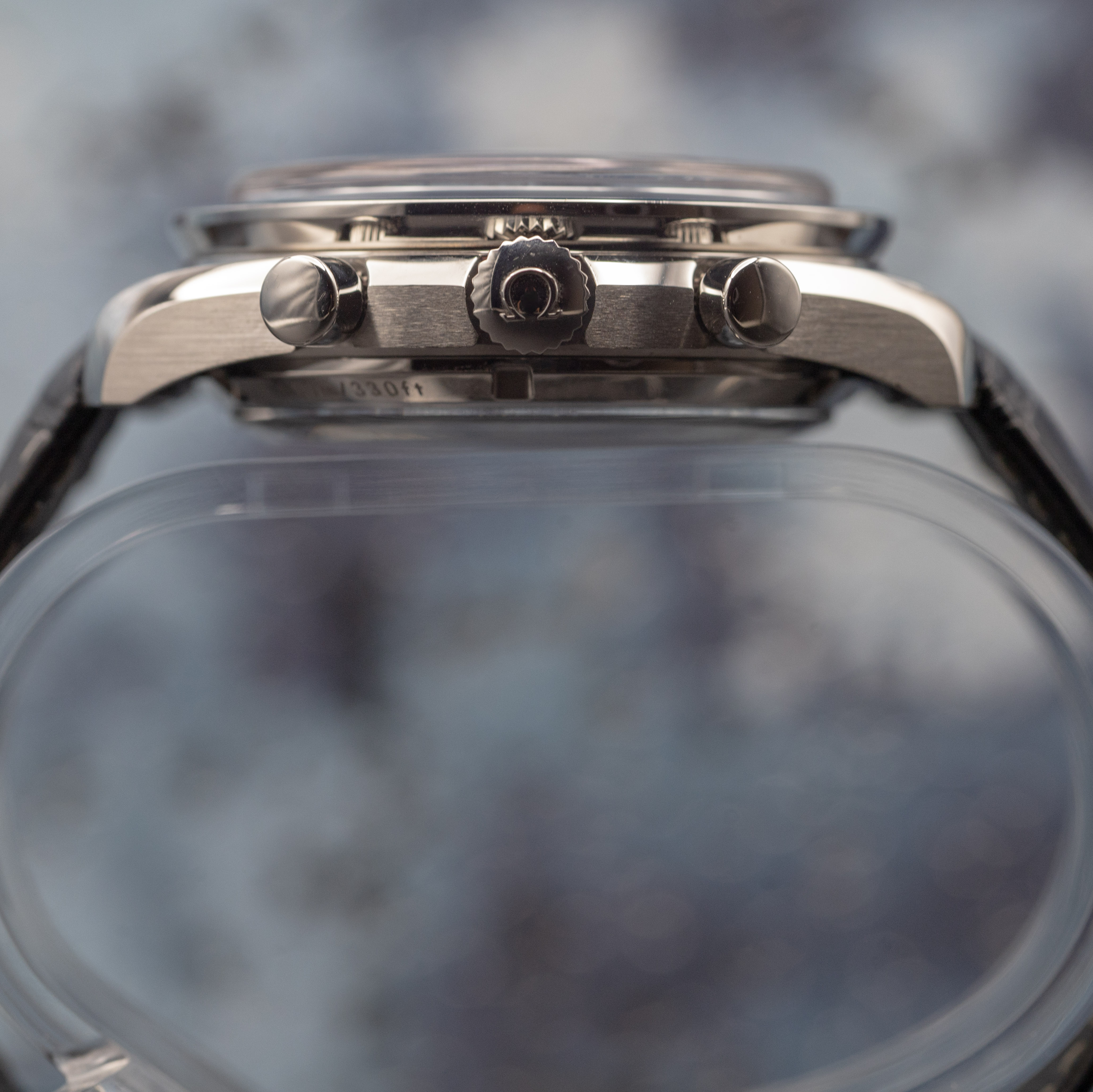 Omega Speedmaster Moonphase layered case profile showing stepped tiers and Liquidmetal bezel