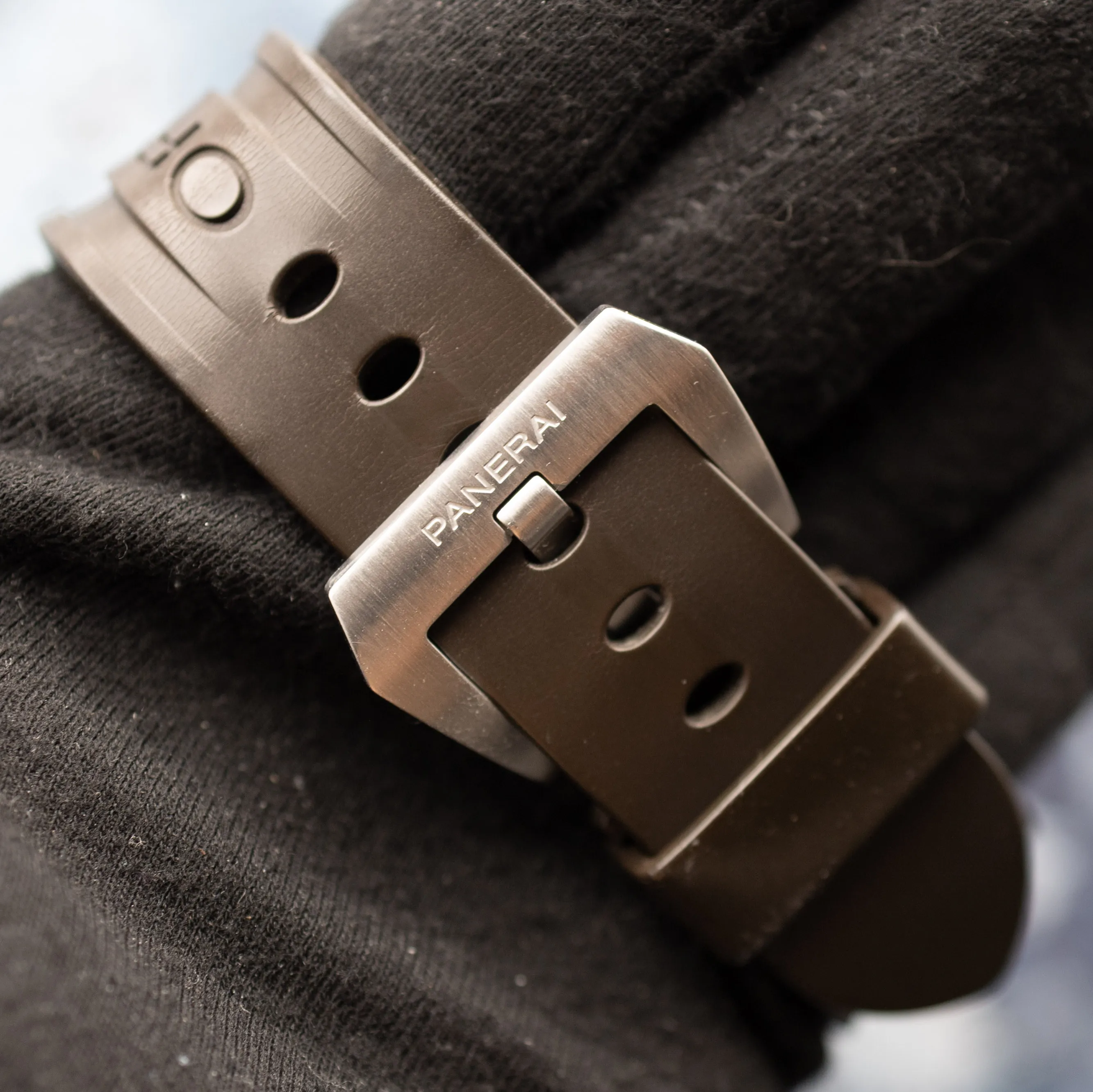 Panerai brushed steel buckle closeup on brown rubber strap