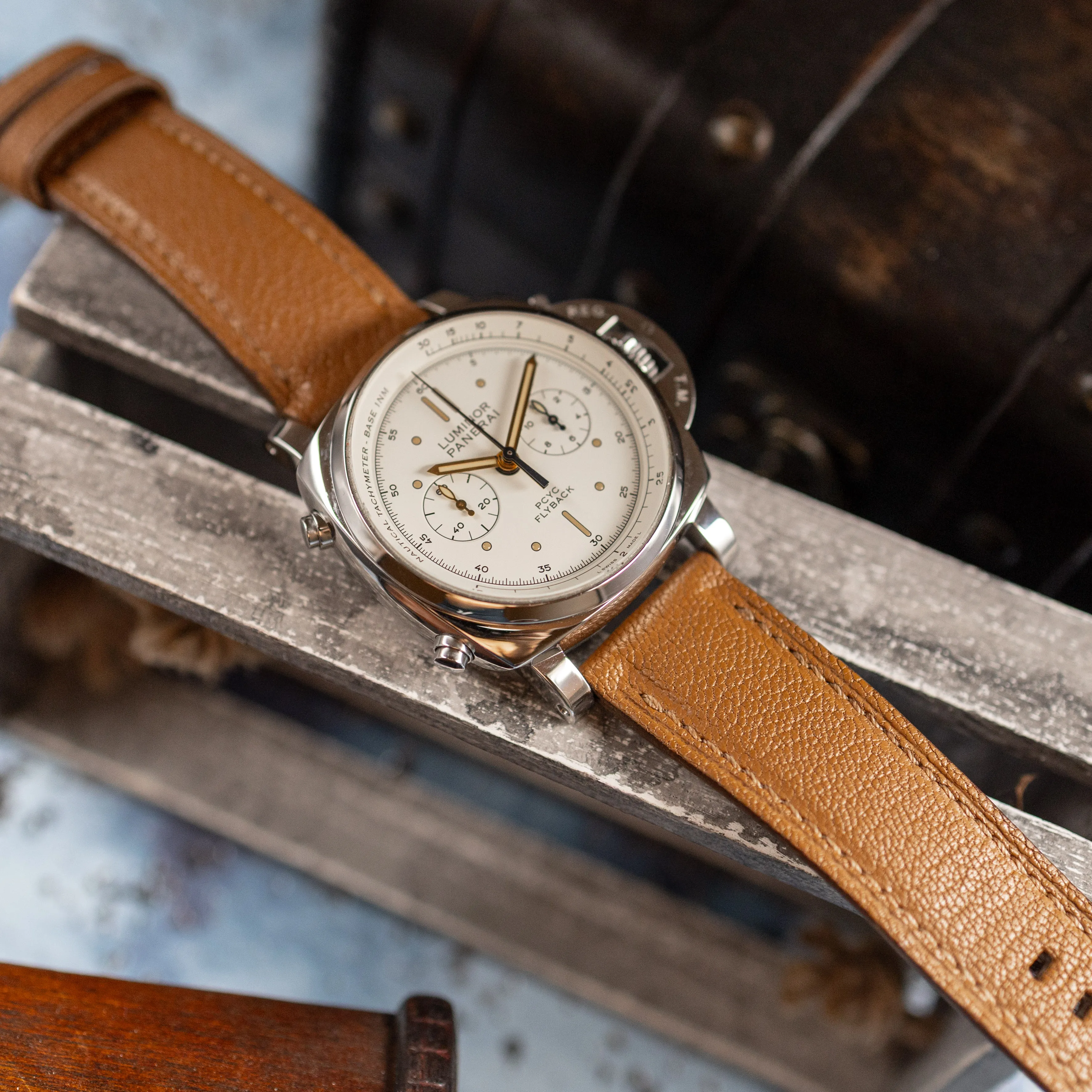 Panerai PAM00654 on brown leather strap angled on a wooden crate